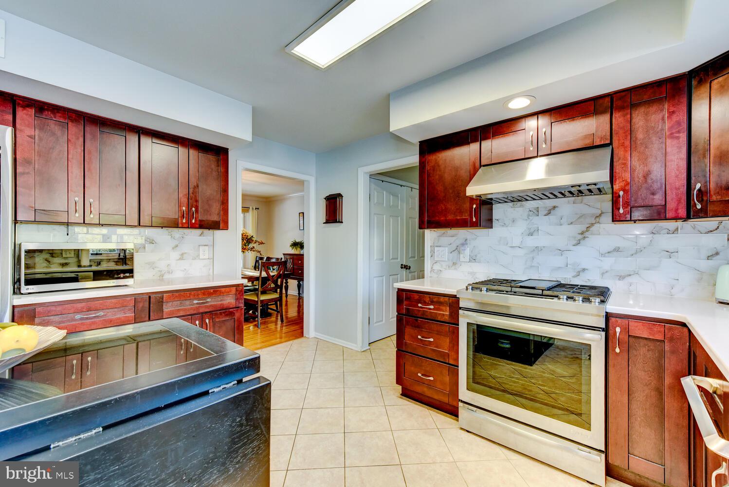 374 Village Road East Princeton Junction, NJ 08550 - Photo 24 of 54 a kitchen with stainless steel appliances a stove sink and cabinets