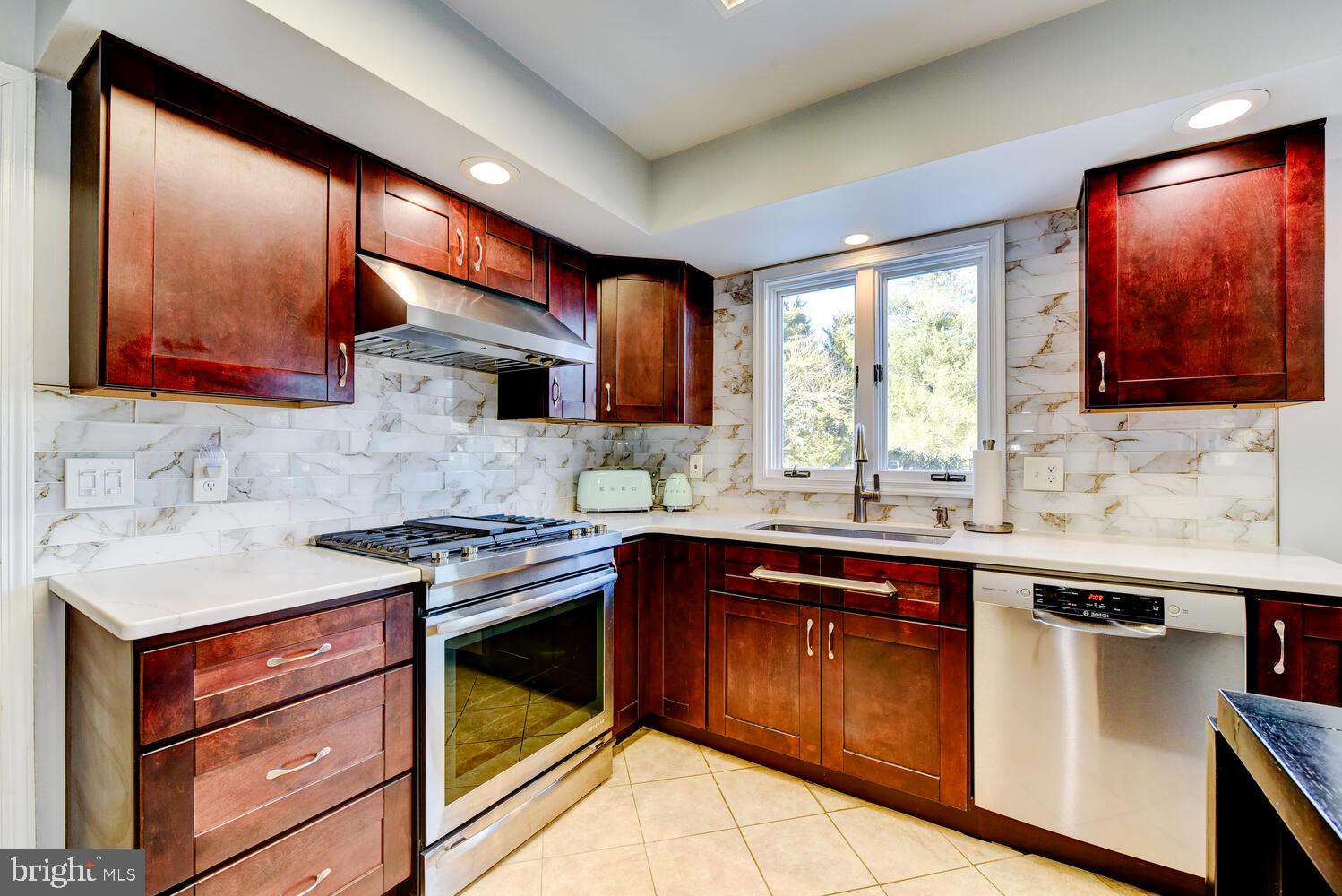 374 Village Road East Princeton Junction, NJ 08550 - Photo 26 of 54 a kitchen with a stove sink and cabinets