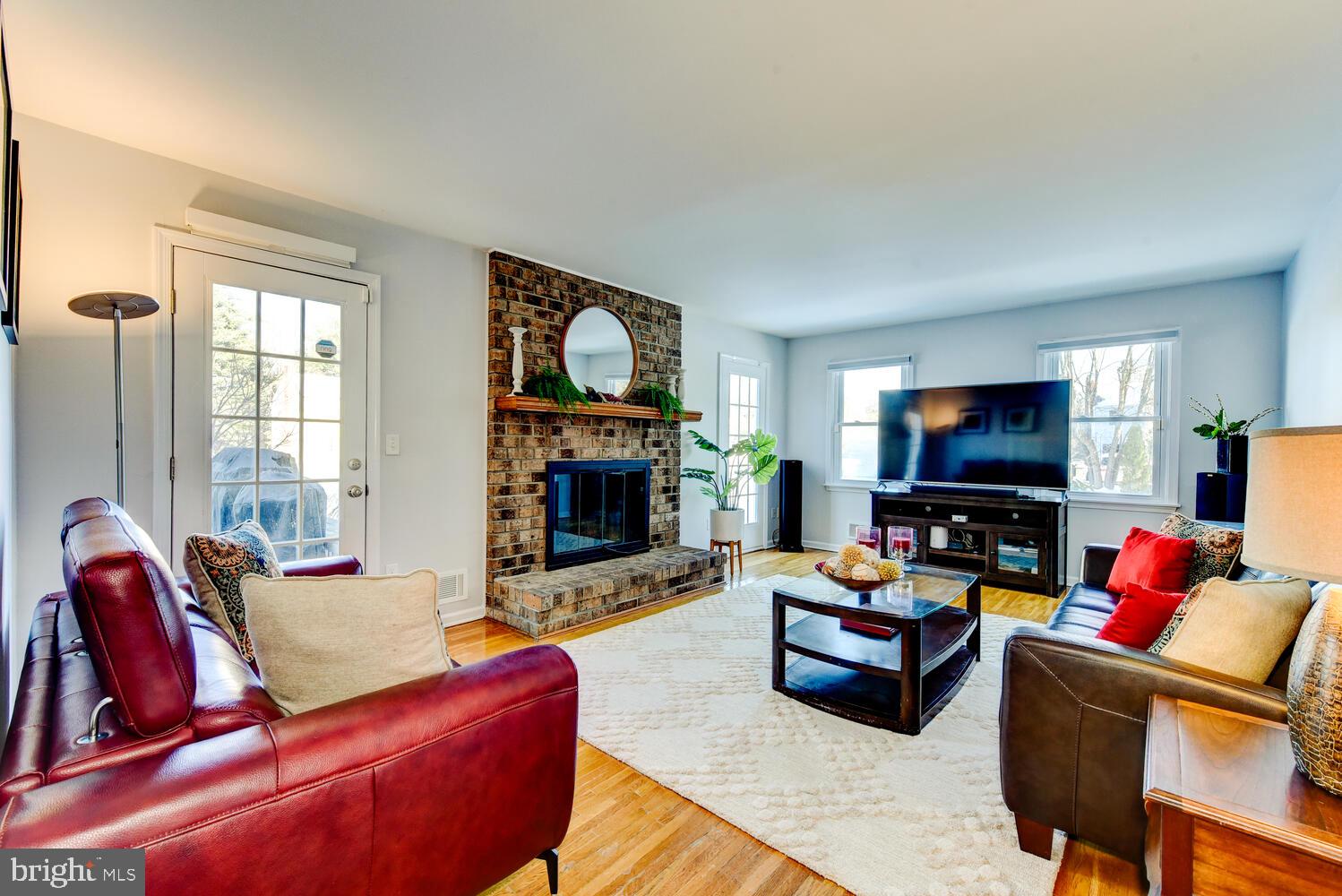 374 Village Road East Princeton Junction, NJ 08550 - Photo 27 of 54 a living room with furniture a flat screen tv and a fireplace