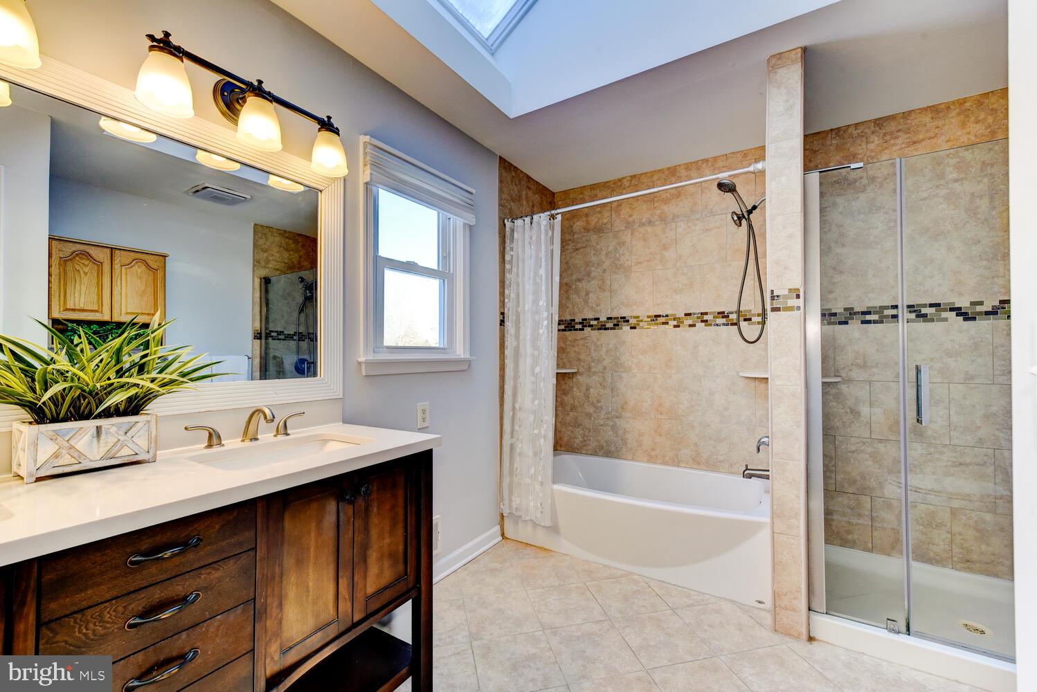 374 Village Road East Princeton Junction, NJ 08550 - Photo 35 of 54 a bathroom with a tub shower sink and mirror