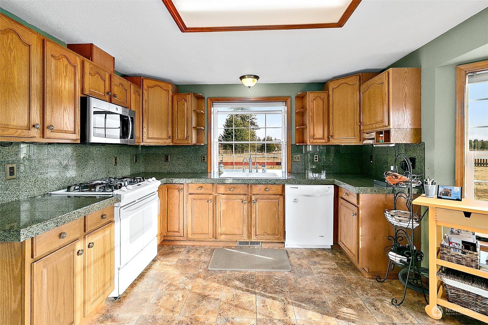 17036 Kaylen Lane Southwest Rochester, WA 98579 - Photo 11 of 40 a kitchen with a sink a stove and a refrigerator