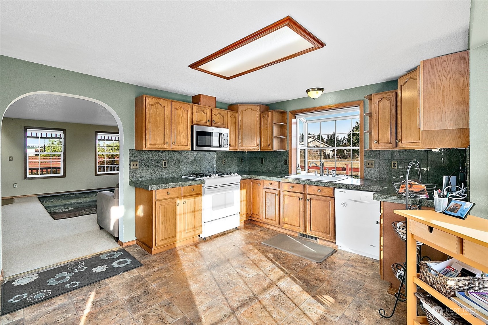 17036 Kaylen Lane Southwest Rochester, WA 98579 - Photo 12 of 40 a kitchen with stainless steel appliances granite countertop a stove a sink and a microwave