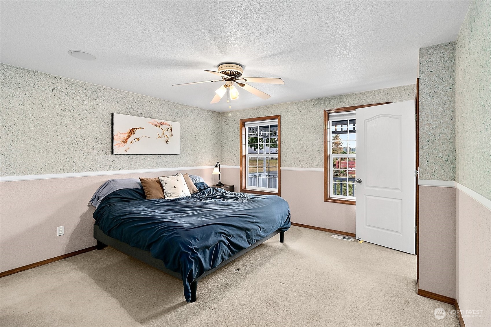 17036 Kaylen Lane Southwest Rochester, WA 98579 - Photo 6 of 40 a spacious bedroom with a large bed and a chandelier