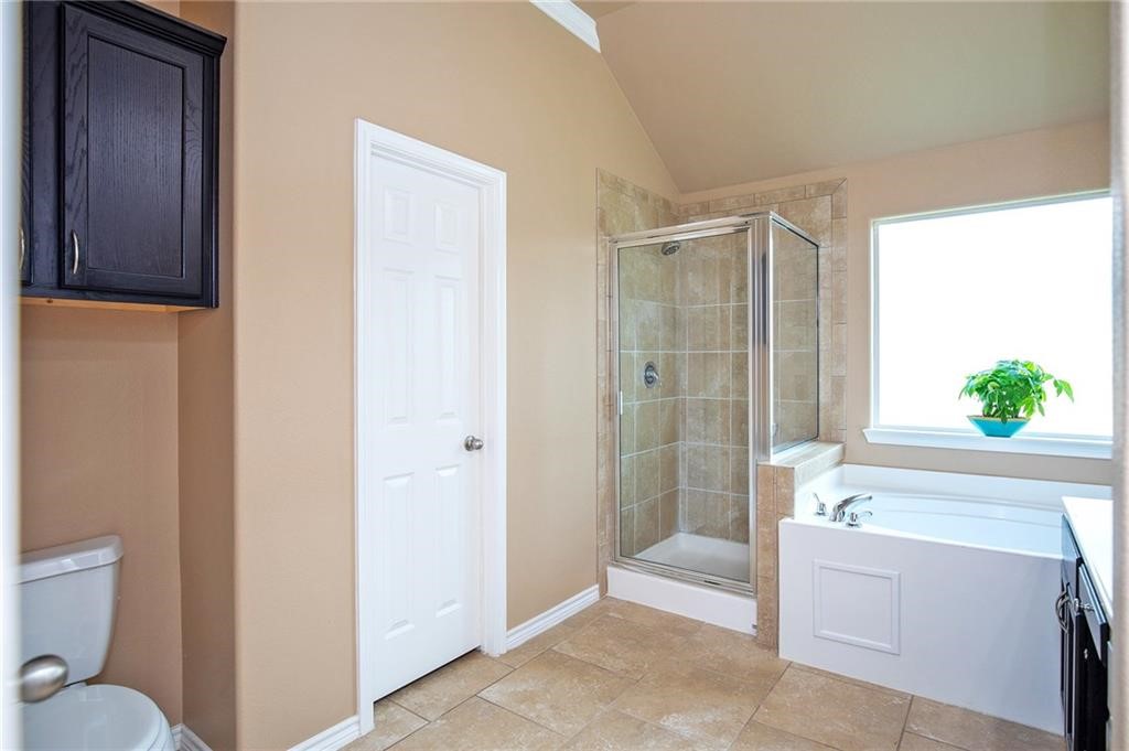 3921 Las Bahias Drive Corpus Christi, TX 78414 - Photo 11 of 16 a spacious bathroom with a granite countertop sink a toilet and shower
