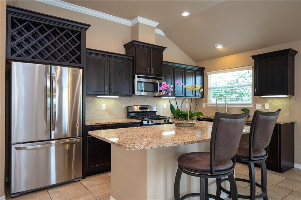 3921 Las Bahias Drive Corpus Christi, TX 78414 - Photo 6 of 16 a kitchen with stainless steel appliances granite countertop a refrigerator stove microwave and sink