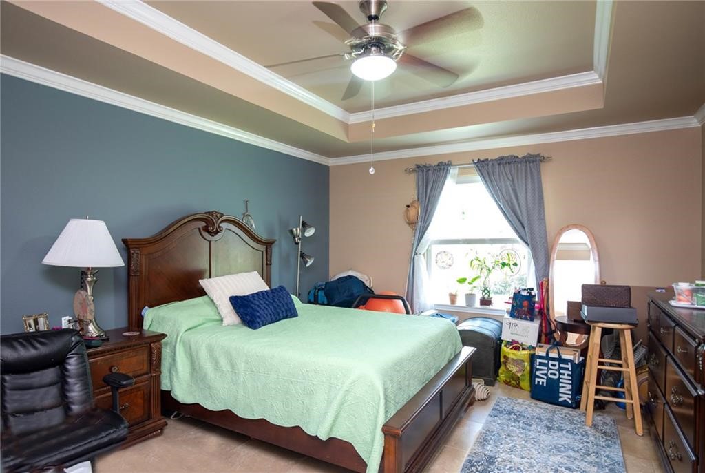 3921 Las Bahias Drive Corpus Christi, TX 78414 - Photo 10 of 16 a bedroom with a bed and a chandelier