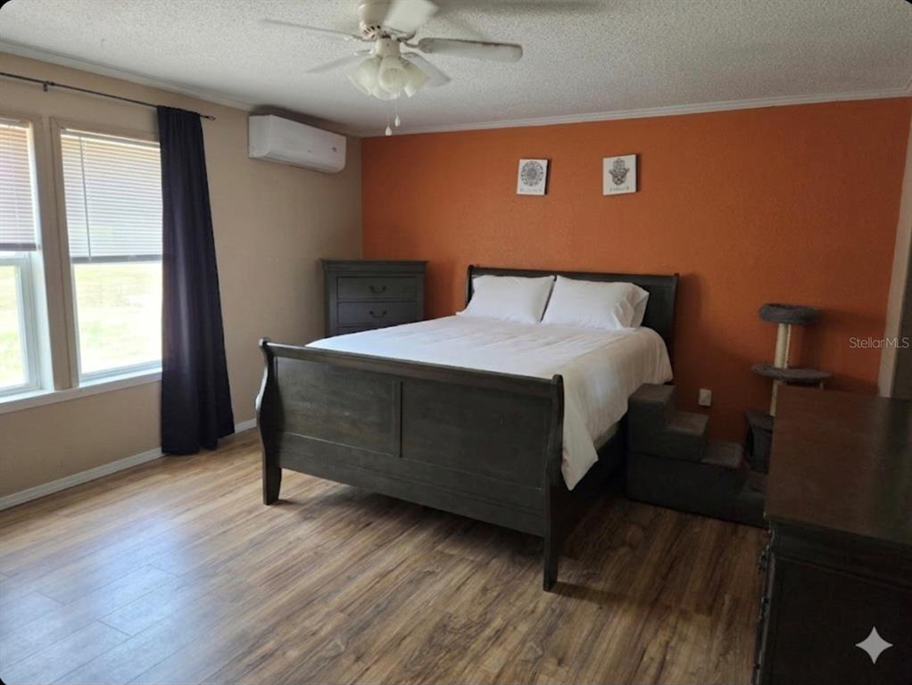 4738 Southwest 166th Court Road Ocala, FL 34481 - Photo 6 of 14 a large bed sitting in a bedroom next to a window