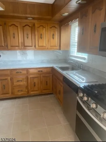 a kitchen with stainless steel appliances granite countertop a stove and a sink