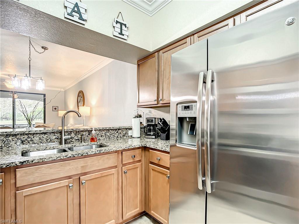 9554 Trevi Court, Unit 4715 Naples, FL 34113 - Photo 11 of 49 a kitchen with stainless steel appliances cabinets and a sink