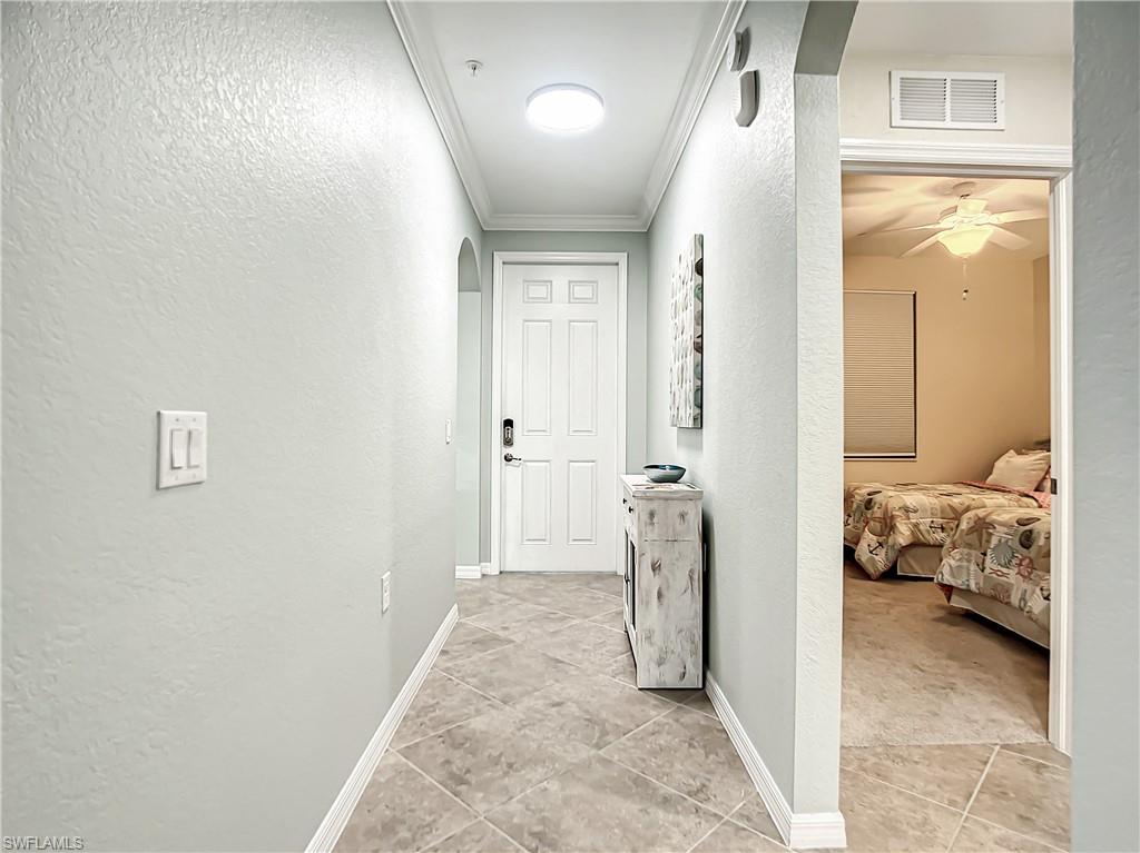 9554 Trevi Court, Unit 4715 Naples, FL 34113 - Photo 16 of 49 a view of a room that has a bed and a window