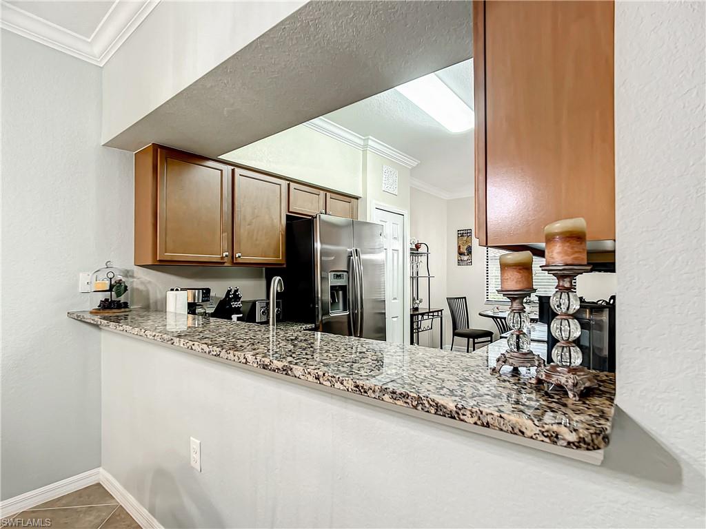 9554 Trevi Court, Unit 4715 Naples, FL 34113 - Photo 18 of 49 a bathroom with a sink and a mirror