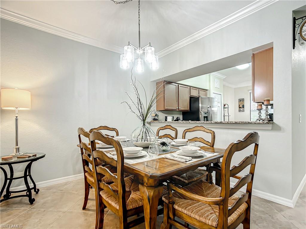 9554 Trevi Court, Unit 4715 Naples, FL 34113 - Photo 21 of 49 a view of a dining room and livingroom with furniture