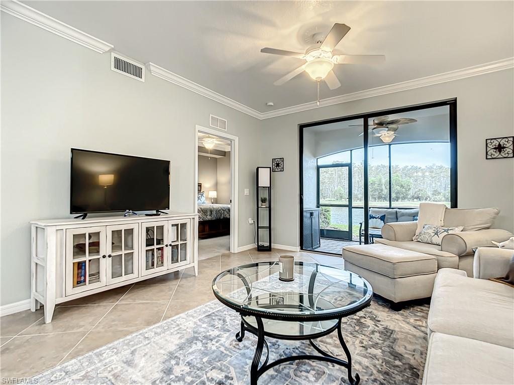 9554 Trevi Court, Unit 4715 Naples, FL 34113 - Photo 26 of 49 a living room with furniture and a flat screen tv