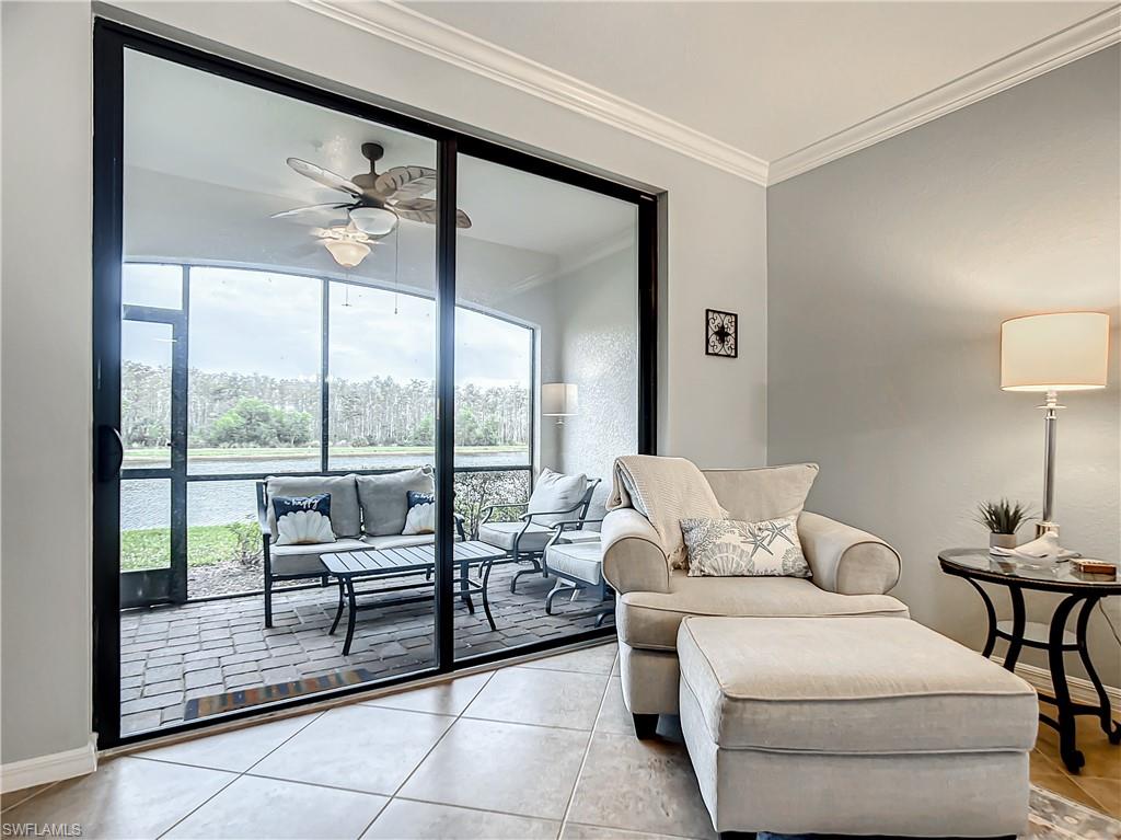 9554 Trevi Court, Unit 4715 Naples, FL 34113 - Photo 28 of 49 a living room with furniture and a floor to ceiling window
