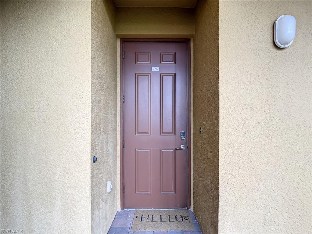 9554 Trevi Court, Unit 4715 Naples, FL 34113 - Photo 3 of 49 a view of a hallway with wooden floor