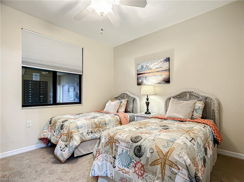 9554 Trevi Court, Unit 4715 Naples, FL 34113 - Photo 32 of 49 a bedroom with two beds and painting on the wall