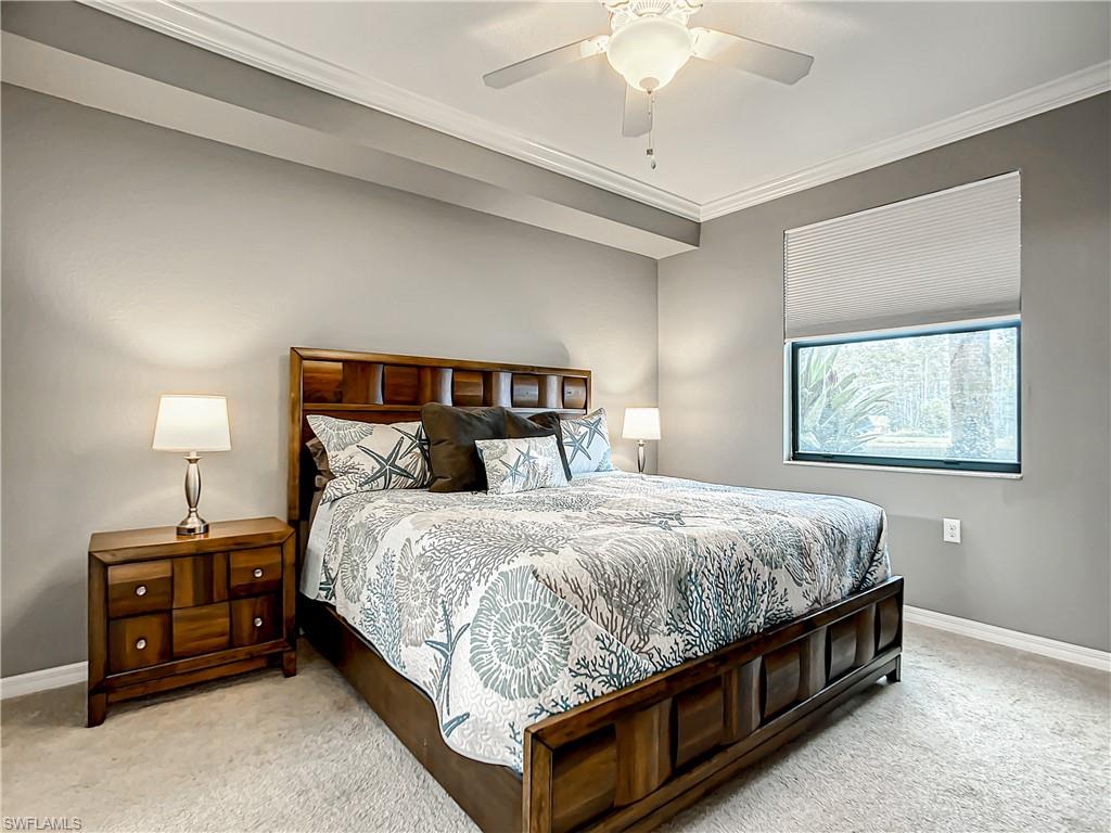 9554 Trevi Court, Unit 4715 Naples, FL 34113 - Photo 39 of 49 a bed sitting in a bedroom next to a lamp