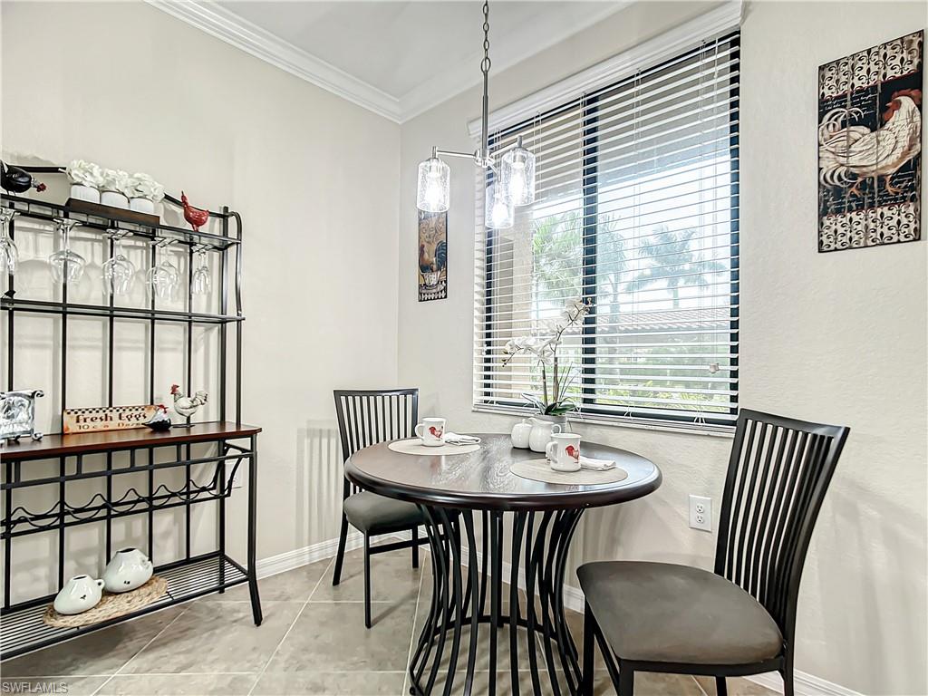 9554 Trevi Court, Unit 4715 Naples, FL 34113 - Photo 4 of 49 a view of a dining room with furniture and window