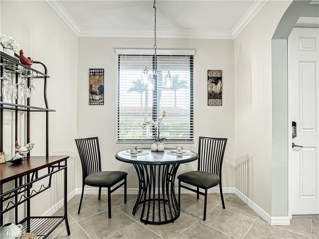9554 Trevi Court, Unit 4715 Naples, FL 34113 - Photo 5 of 49 a dining room with furniture and window