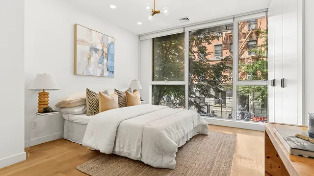a bedroom with a large bed and a large window