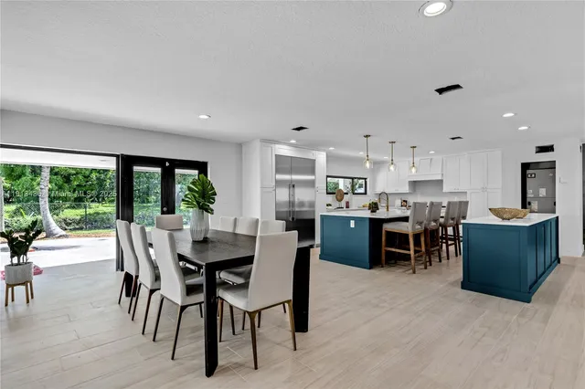 a spacious bedroom with a large bed and a potted plant
