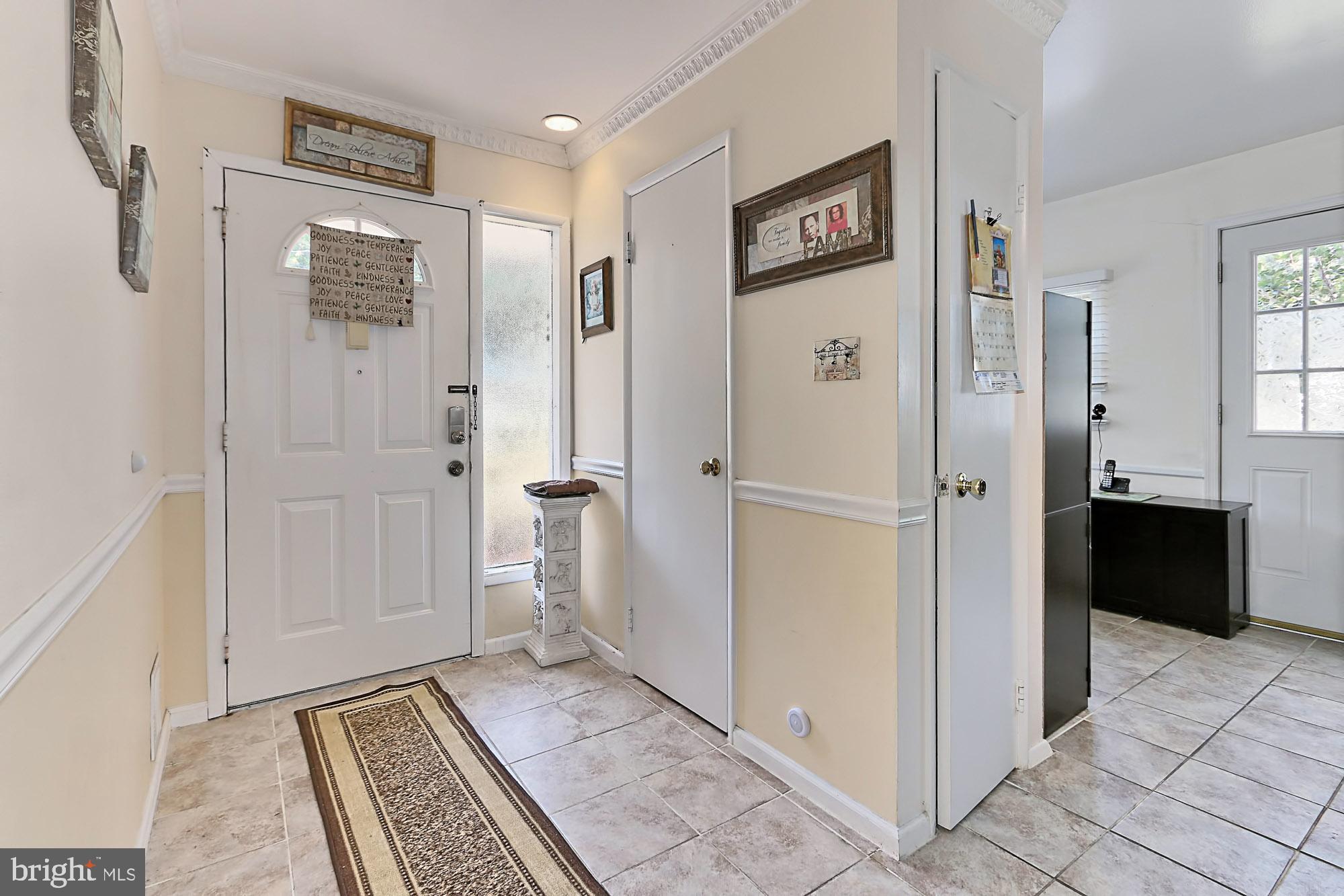 Inviting foyer with ceramic tile flooring