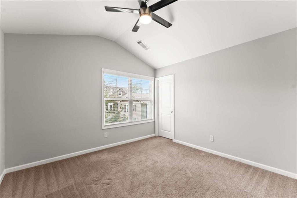 6021 Harbour Mist Drive Flowery Branch, GA 30542 - Photo 18 of 36 an empty room with ceiling fan and windows