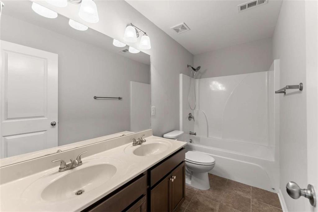 6021 Harbour Mist Drive Flowery Branch, GA 30542 - Photo 20 of 36 a bathroom with a sink a toilet and shower