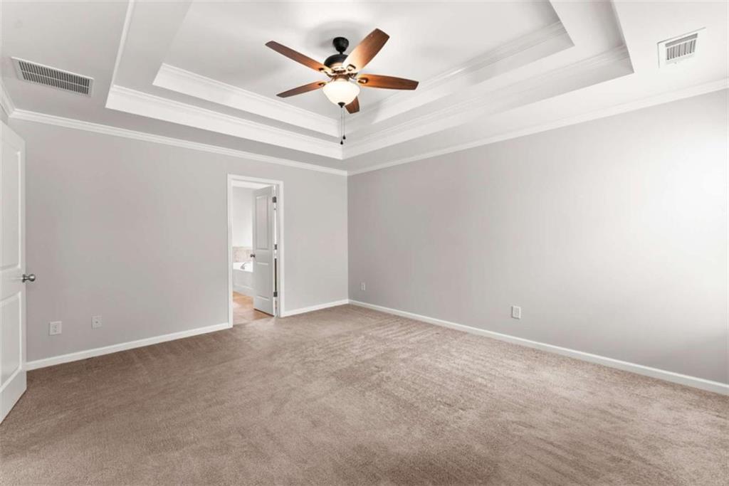 6021 Harbour Mist Drive Flowery Branch, GA 30542 - Photo 25 of 36 an empty room with ceiling fan and window