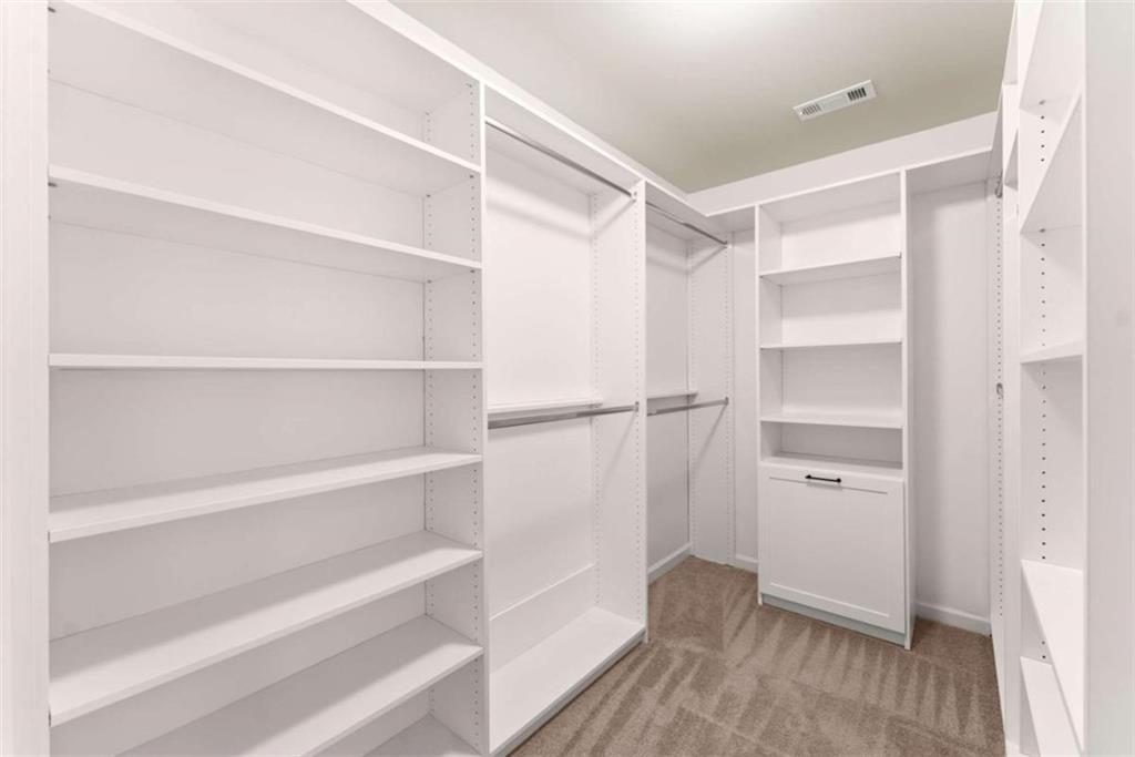 6021 Harbour Mist Drive Flowery Branch, GA 30542 - Photo 27 of 36 a view of walk in closet with empty racks