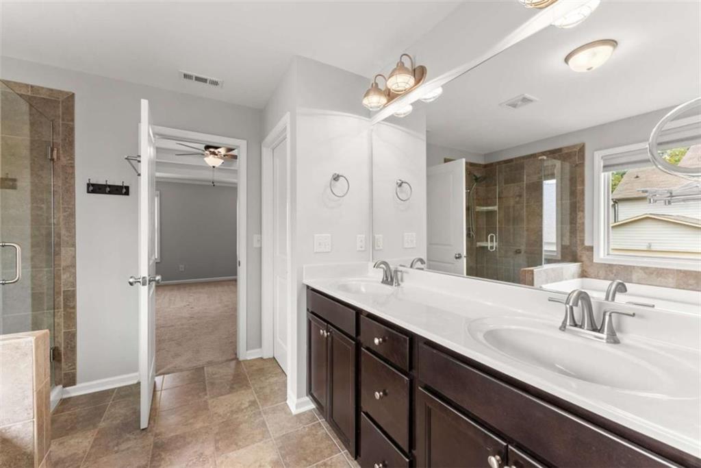 6021 Harbour Mist Drive Flowery Branch, GA 30542 - Photo 28 of 36 a bathroom with a double vanity sink mirror and shower