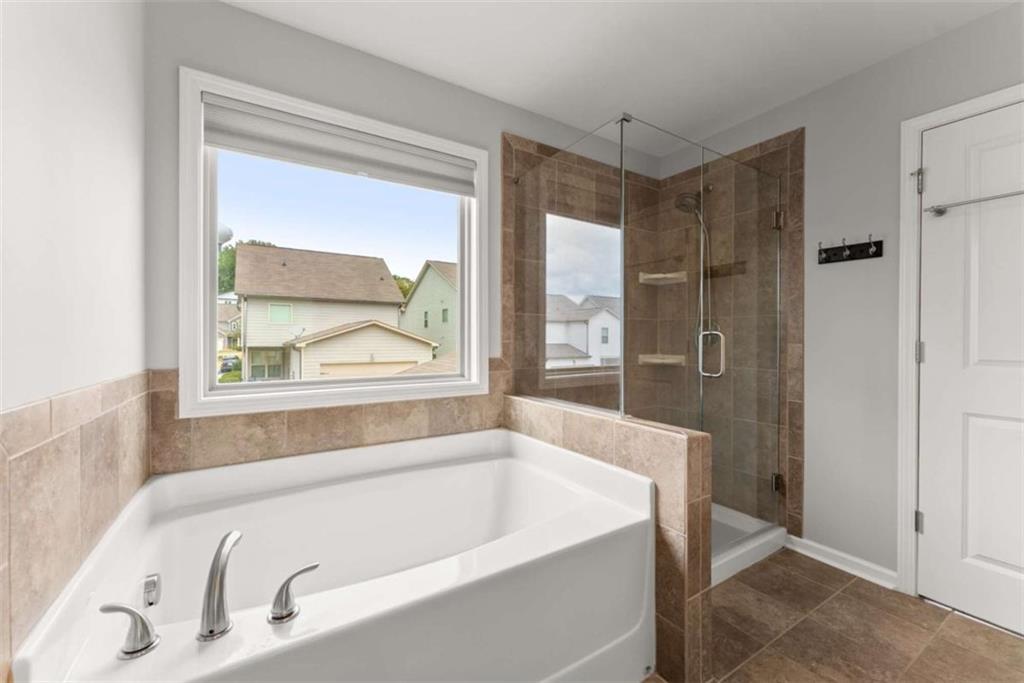 6021 Harbour Mist Drive Flowery Branch, GA 30542 - Photo 29 of 36 a bathroom with a tub and a window