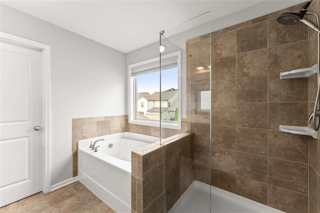 6021 Harbour Mist Drive Flowery Branch, GA 30542 - Photo 30 of 36 a bathroom with a bathtub and sink