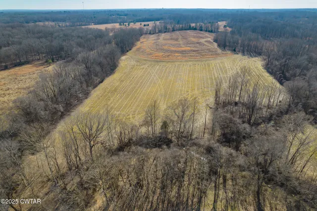 a view of basketball court with wooden fence
