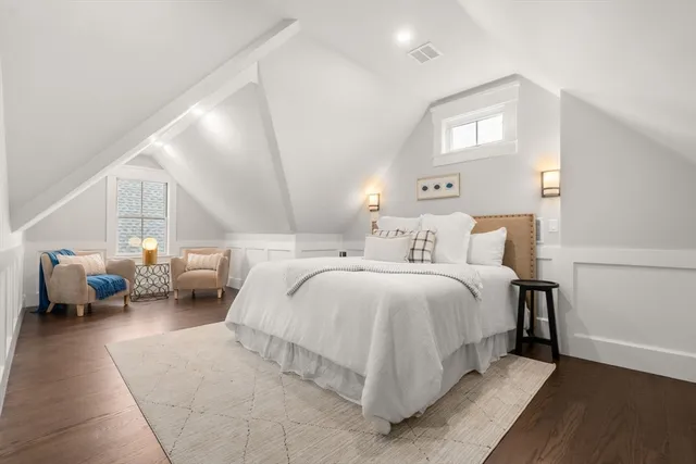 a bedroom with a bed couch and a window