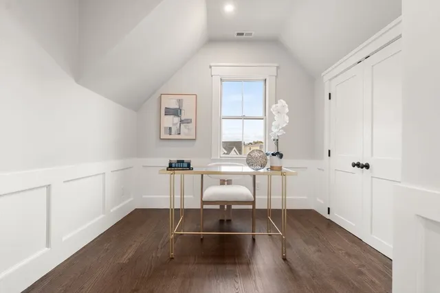 a living room with furniture a window and wooden floor