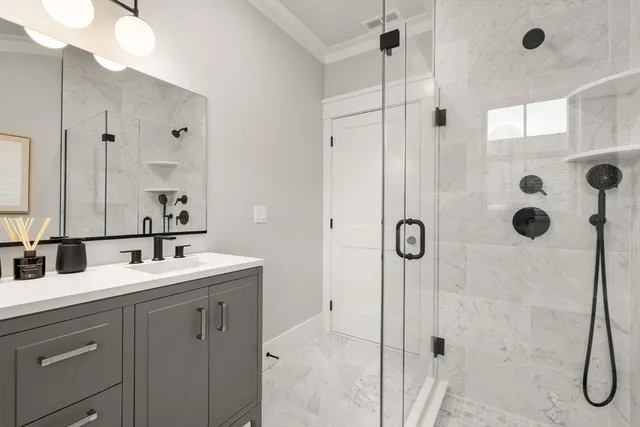 a bathroom with a shower sink and mirror