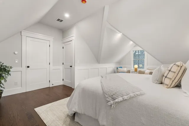 a bedroom with a large bed and a couch