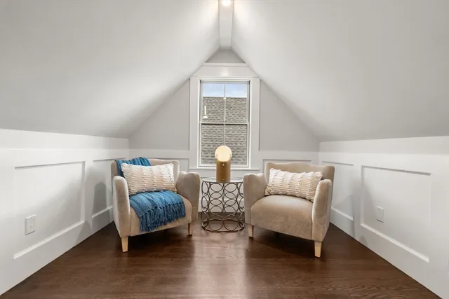 a living room with furniture and a lamp