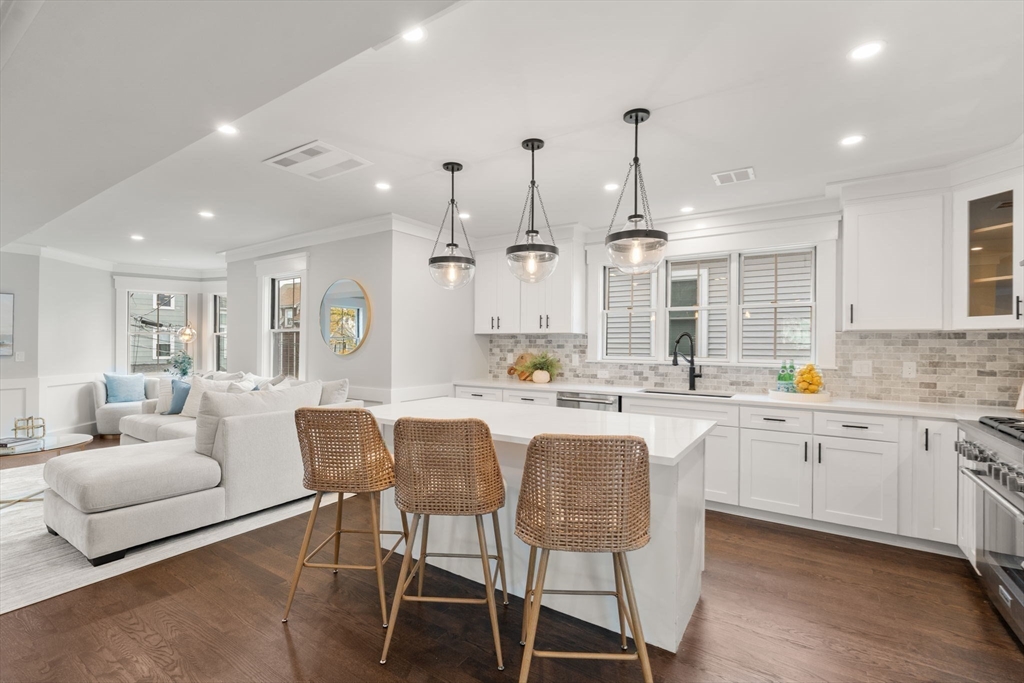 11 Macarthur Street, Unit B Somerville, MA 02145 - Photo 9 of 28 a large kitchen with granite countertop lots of white furniture and appliances