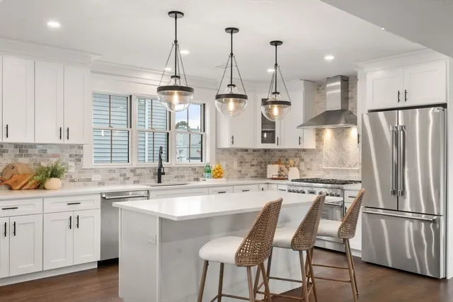 a kitchen with appliances a sink and cabinets