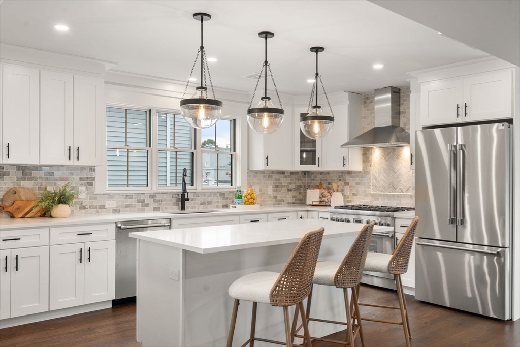 11 Macarthur Street, Unit B Somerville, MA 02145 - Photo 10 of 28 a kitchen with appliances a sink and cabinets