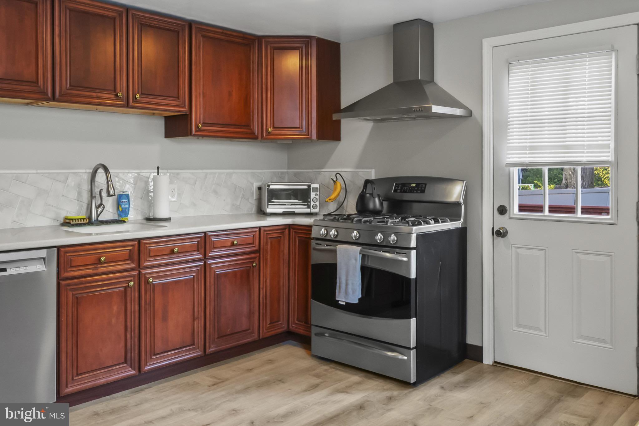 113 Risdon Street Mount Holly, NJ 08060 - Photo 9 of 25 Charming kitchen with rich wood cabinetry.