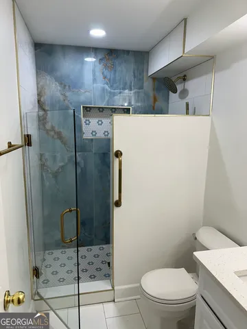 a bathroom with a toilet and a shower