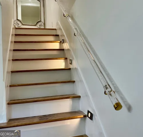 a bedroom with a bed and a lamp