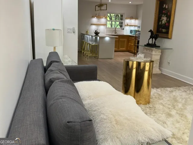a living room with granite countertop furniture a fireplace and a flat screen tv