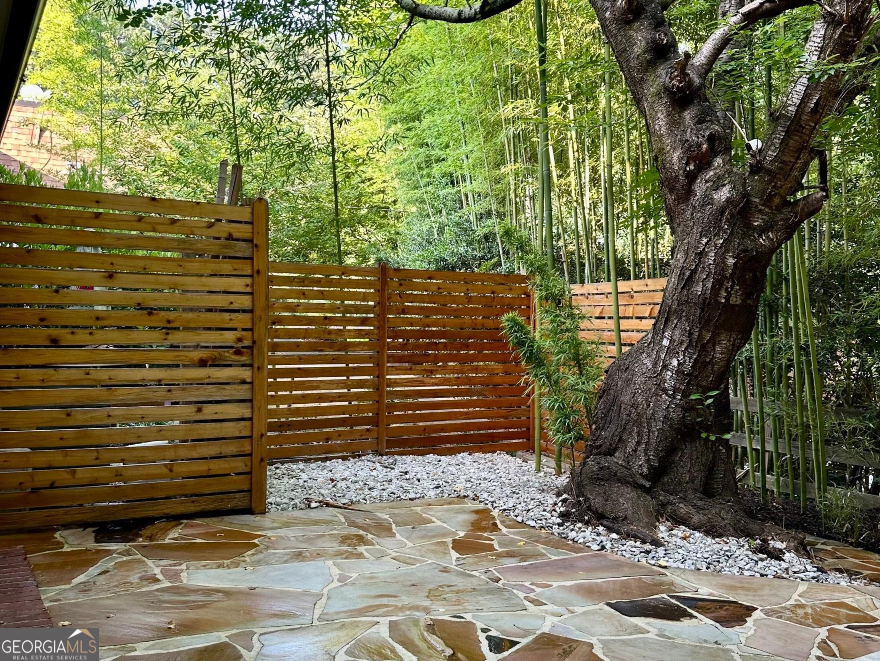 1261 Lavista Road Northeast, Unit N8 Atlanta, GA 30324 - Photo 26 of 29 a view of a pathway of a yard with plants and large trees