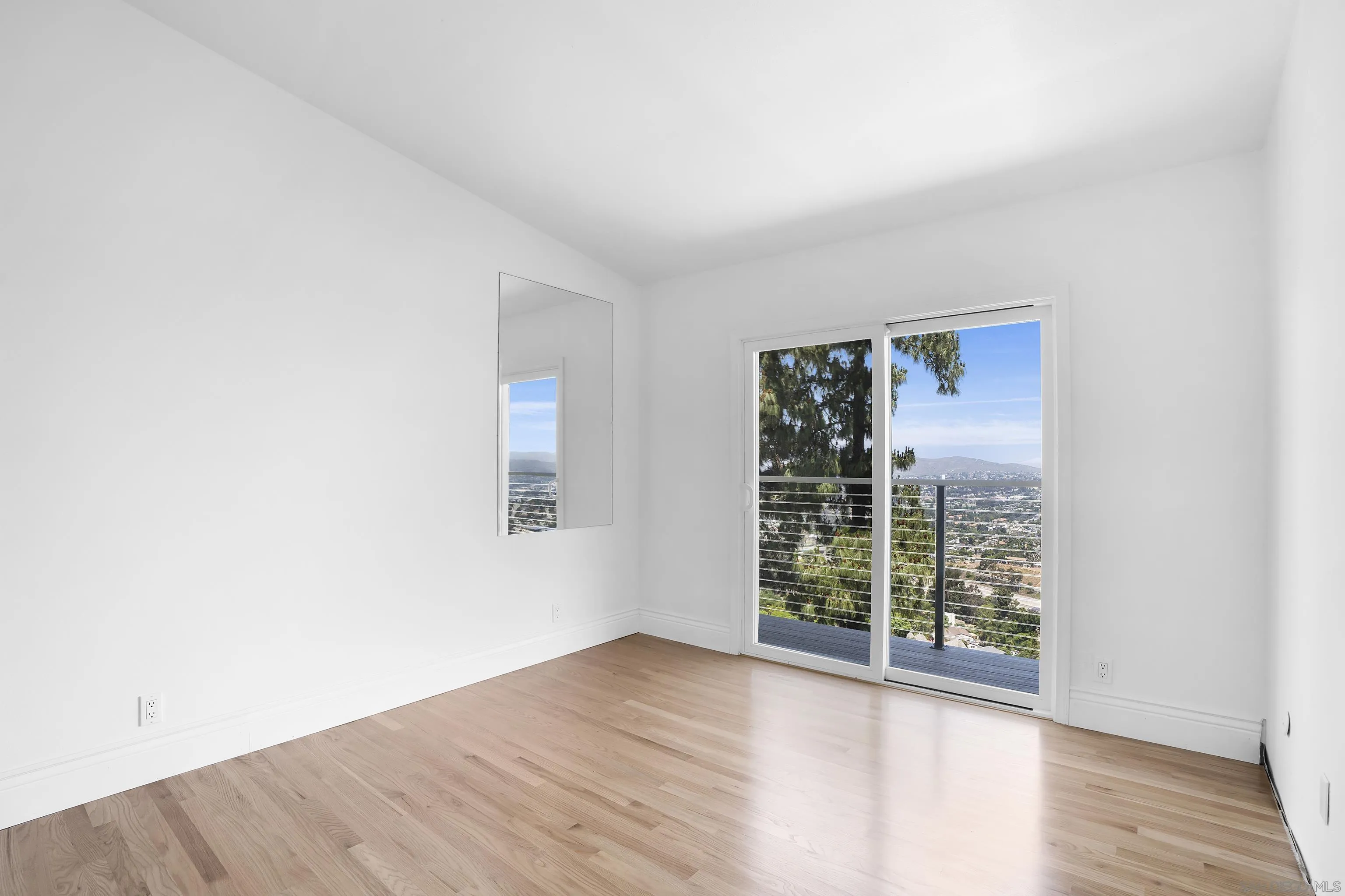 9612 Summit Circle La Mesa, CA 91941 - Photo 29 of 35 an empty room with wooden floor and windows