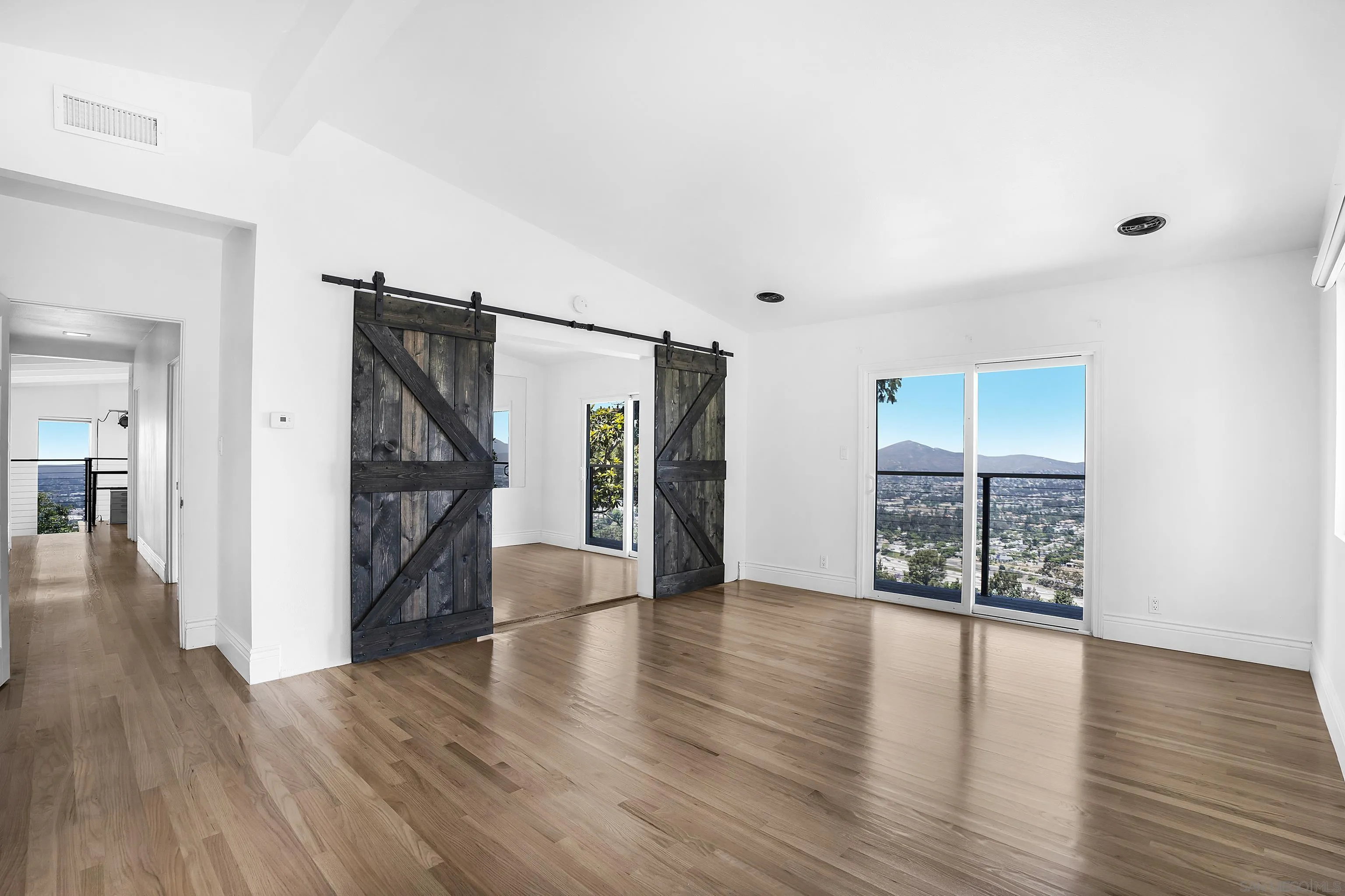 9612 Summit Circle La Mesa, CA 91941 - Photo 31 of 35 a view of an empty room with wooden floor and a window