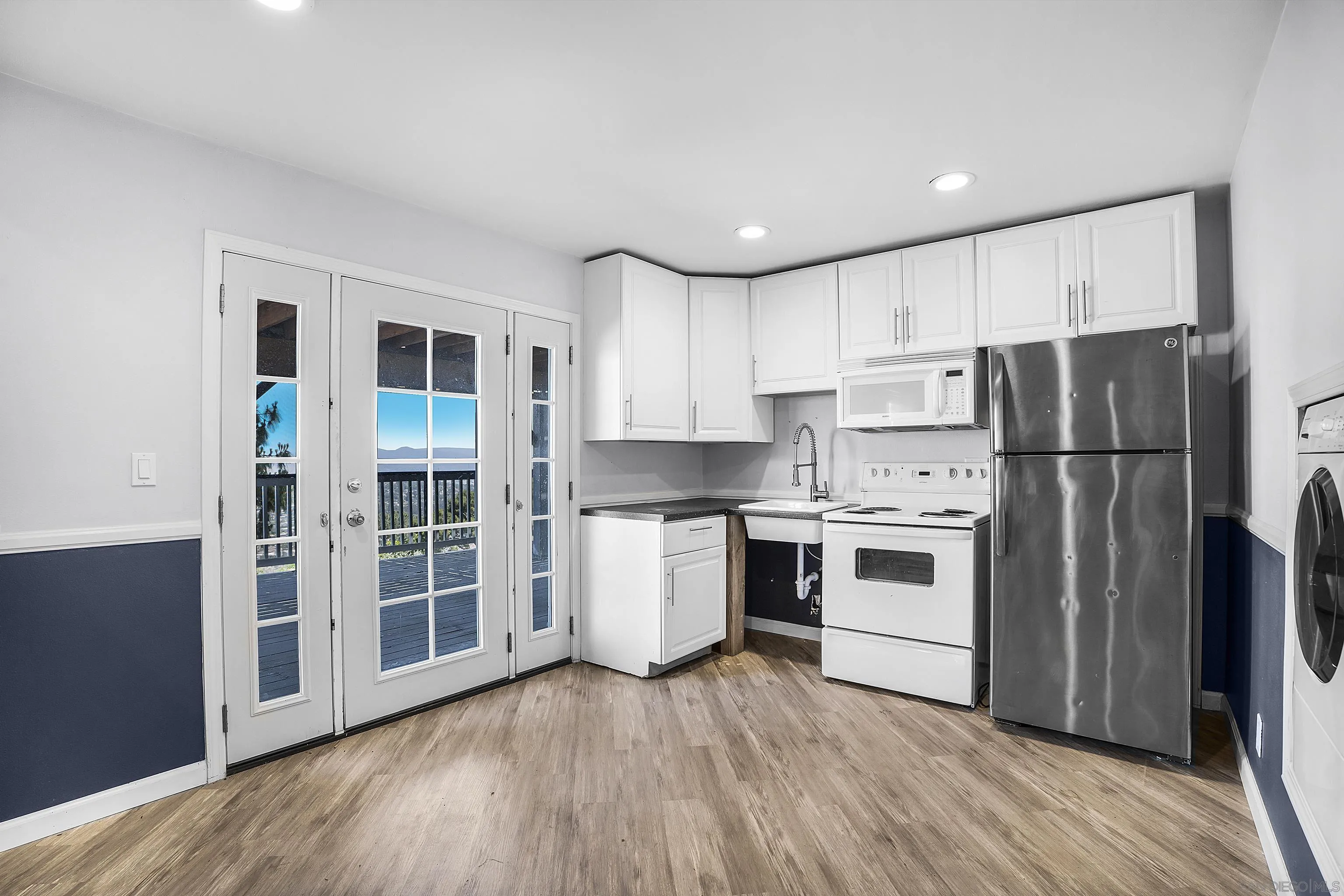 9612 Summit Circle La Mesa, CA 91941 - Photo 35 of 35 a kitchen with a refrigerator a stove top oven and wooden floor